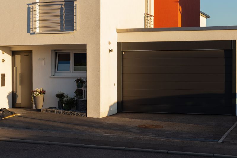 enclosed carport with a black gate