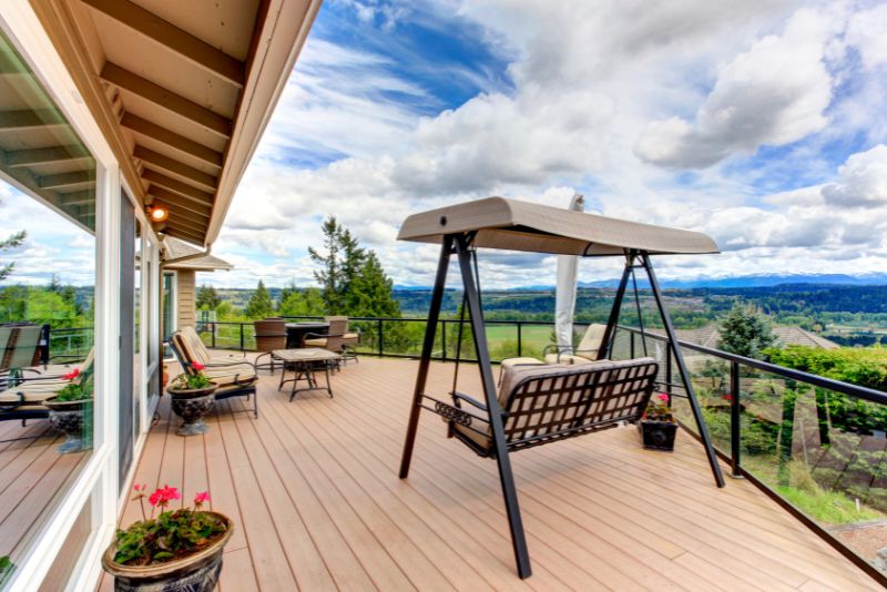 composite deck patio with a hanging swing chair
