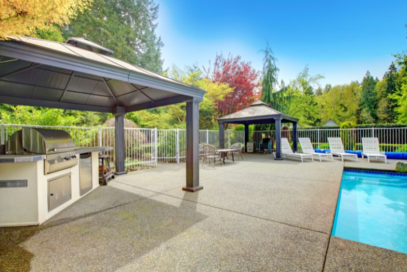 pool deck area with a cooking area and a lounge area